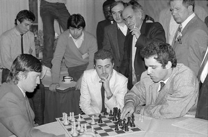 Karpov and Kasparov analysing as Bachar Kouatly and Mikhail Tal watch