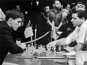 Russian chess grandmasters Boris Spassky, right, and Anatoly Karpov, left,  shake hands the news